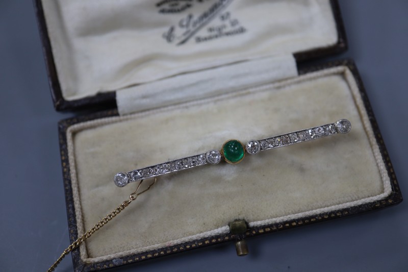 An early 20th century yellow metal, cabochon emerald and millegrain set diamond bar brooch, 52mm, gross 3.6 grams.